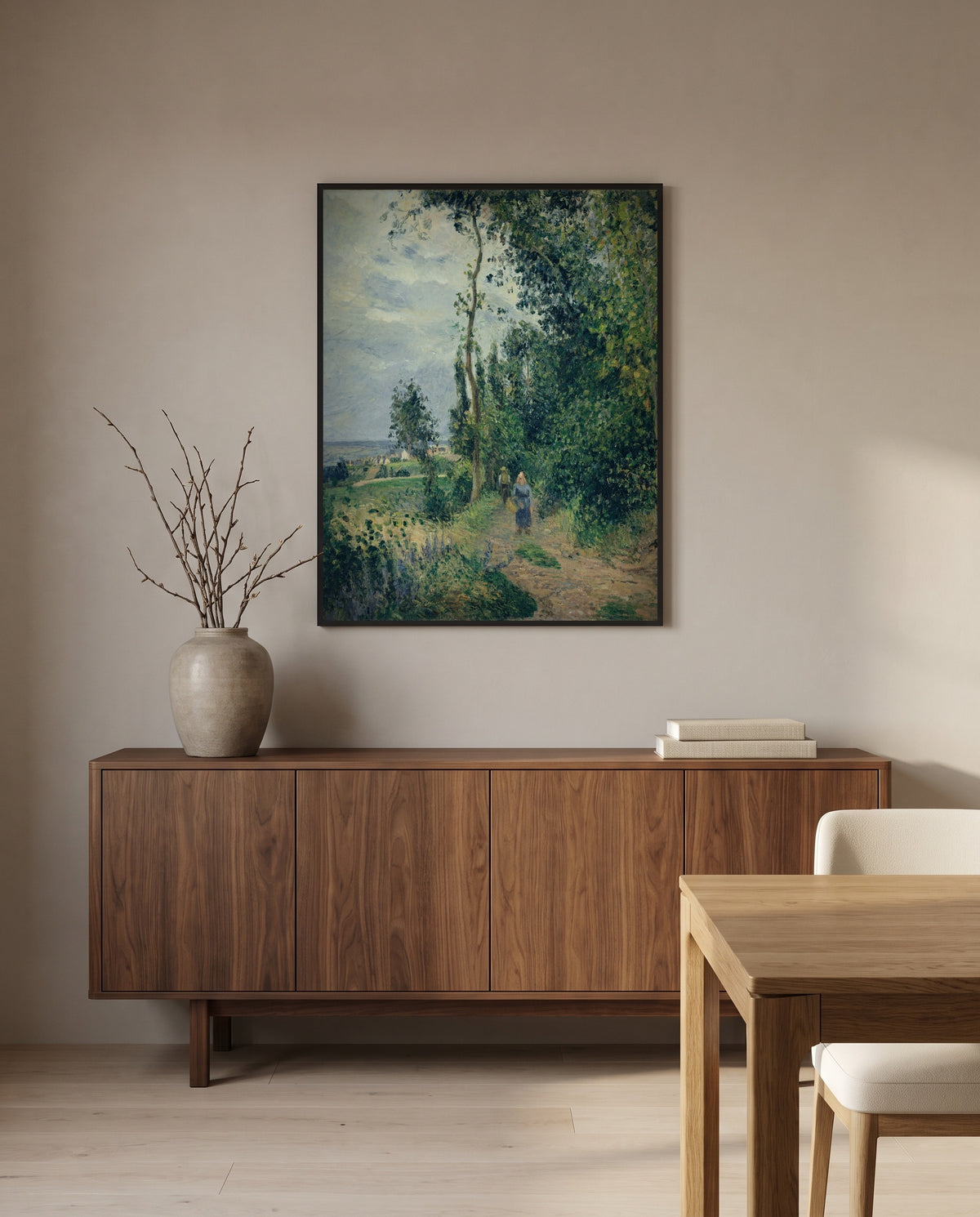 Côte des Grouettes by Camille Pissarro in a black frame above a walnut sideboard in a dining room