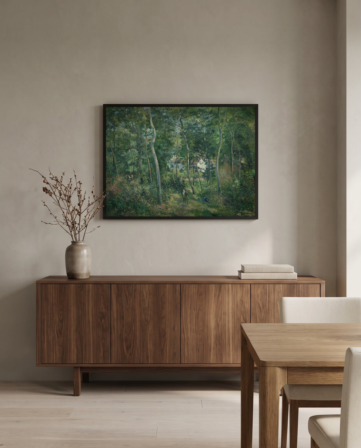 Edge of the Woods, L’Hermitage by Camille Pissarro in a black frame above a walnut sideboard in a dining room