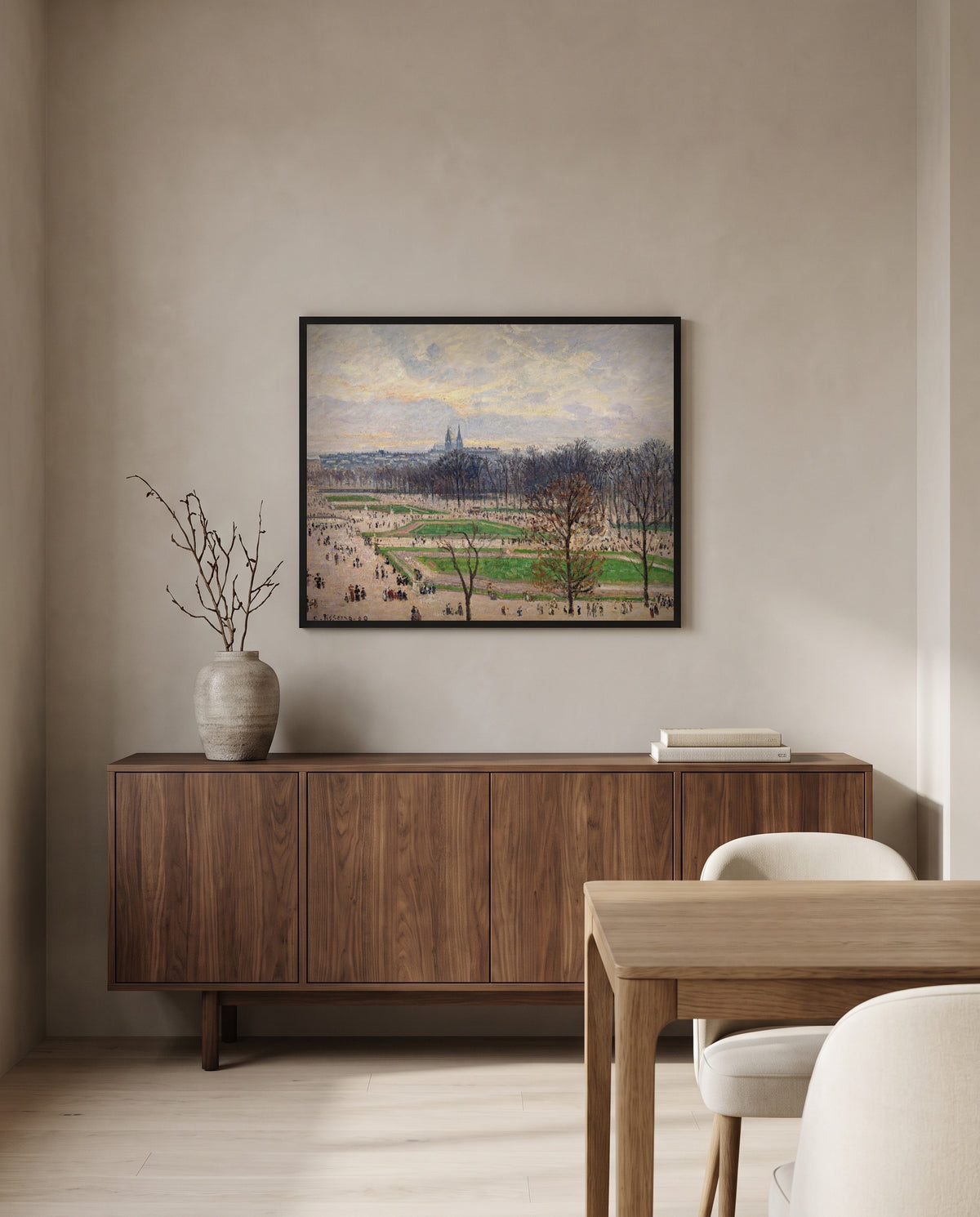 The Tuileries, Winter Afternoon by Camille Pissarro in a black frame above a walnut sideboard in a dining room