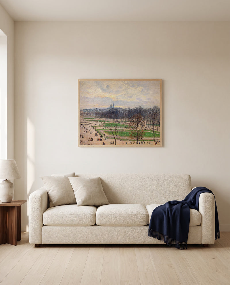 The Tuileries, Winter Afternoon by Camille Pissarro framed in natural oak above a cream sofa in a warm living room