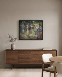 Hay Harvest at Éragny by Camille Pissarro in a black frame above a walnut sideboard in a dining room