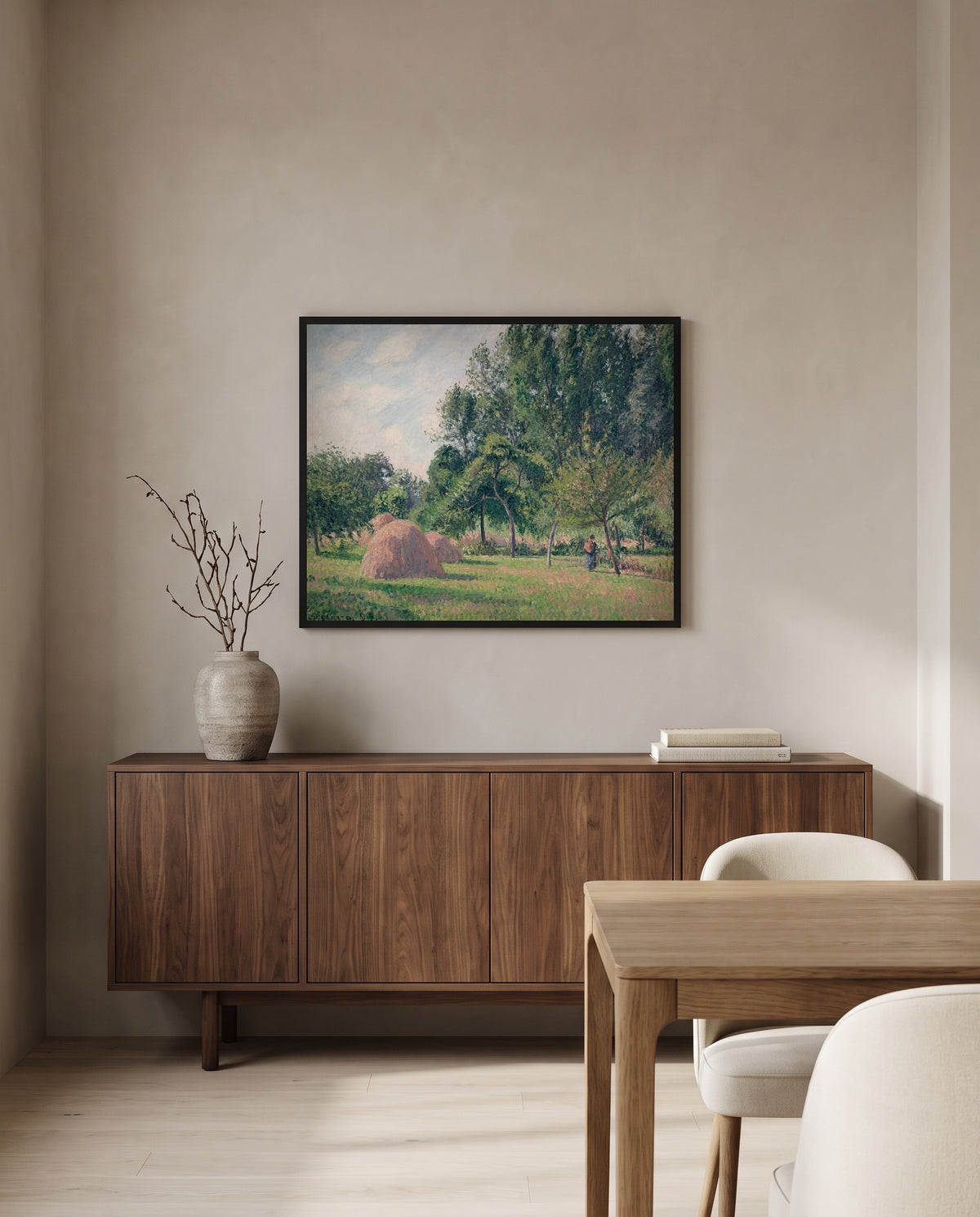 Haystacks, Morning by Camille Pissarro in a black frame above a walnut sideboard in a dining room