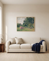 Haystacks, Morning by Camille Pissarro framed in natural oak above a cream sofa in a warm living room