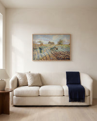 Hoarfrost by Camille Pissarro framed in natural oak above a cream sofa in a warm living room