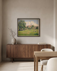 The House of the Deaf Woman by Camille Pissarro in a black frame above a walnut sideboard in a dining room