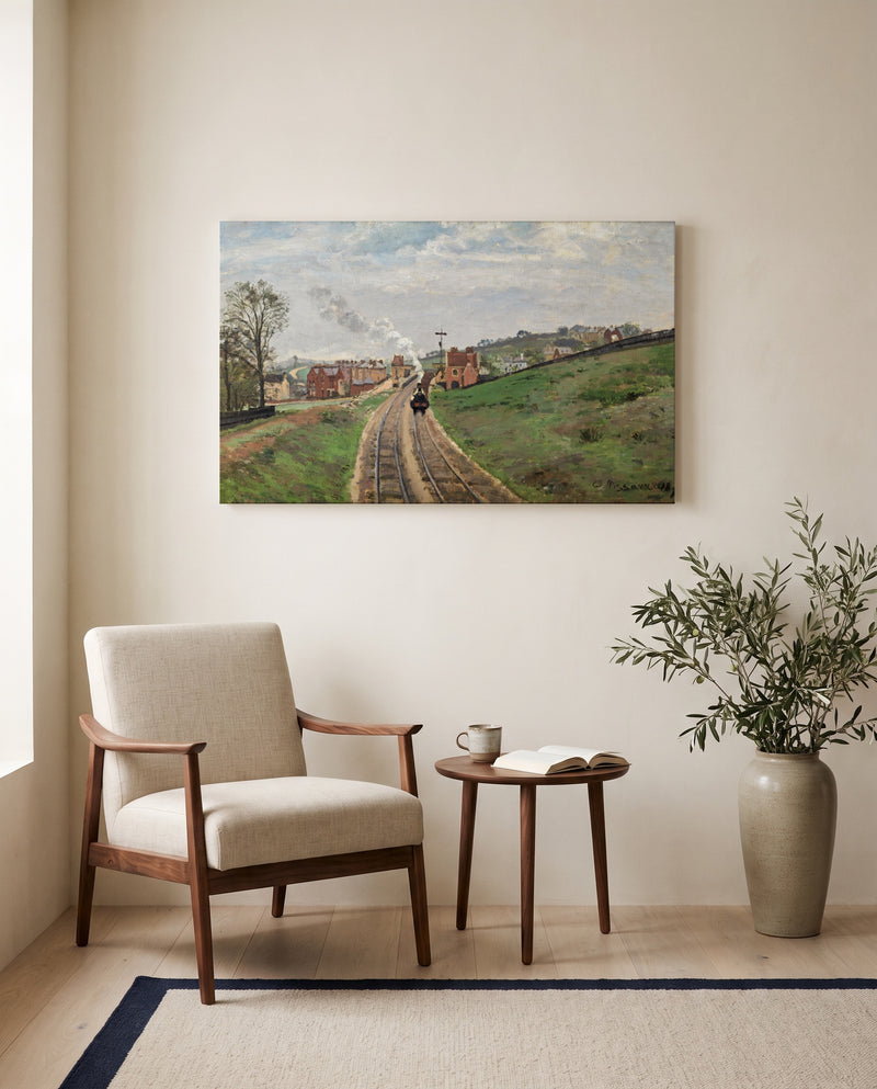 Lordship Lane Station by Camille Pissarro as a stretched canvas above a linen lounge chair in a reading corner