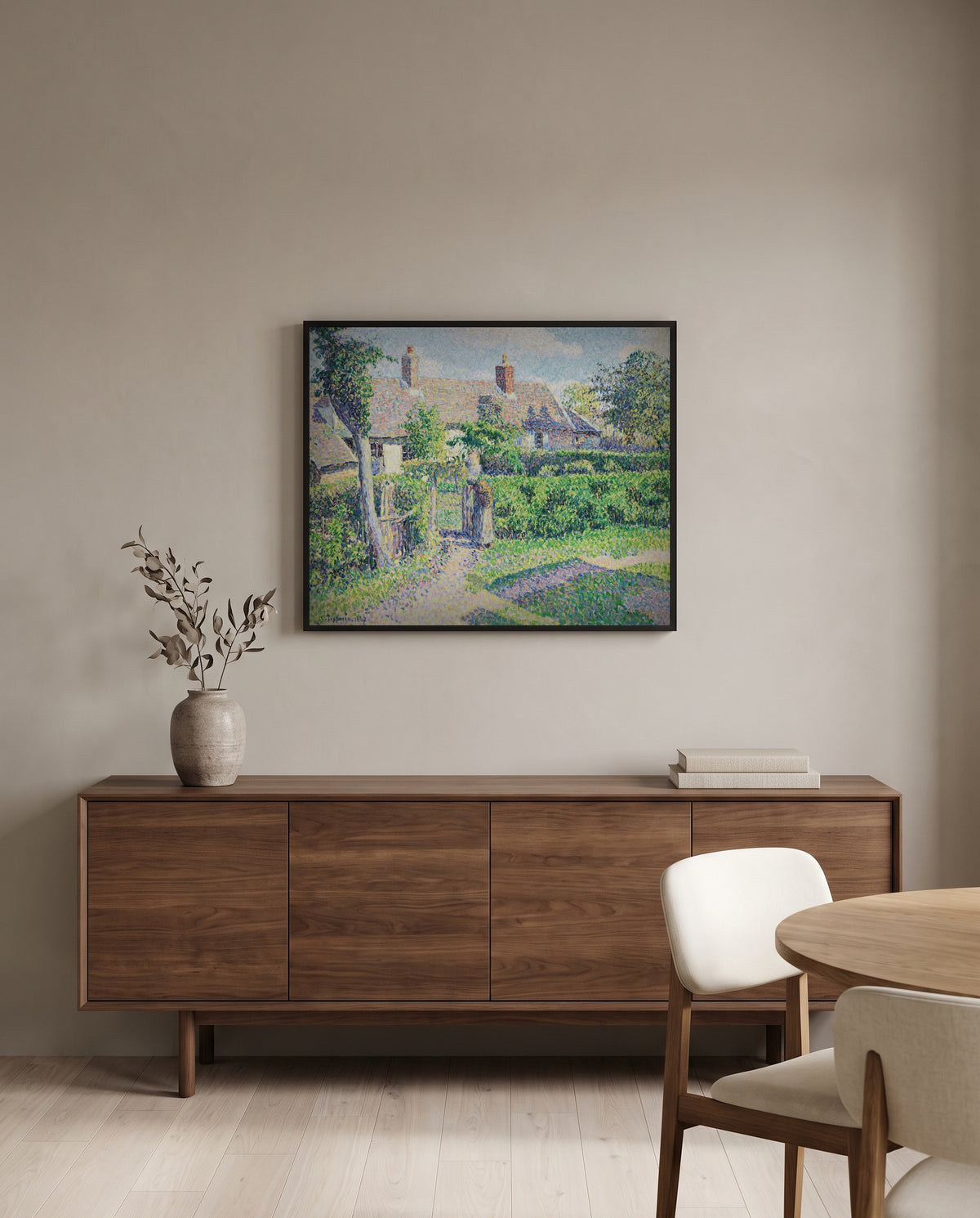 Peasants’ Houses, Éragny by Camille Pissarro in a black frame above a walnut sideboard in a dining room