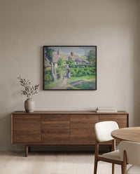 Peasants’ Houses, Éragny by Camille Pissarro in a black frame above a walnut sideboard in a dining room