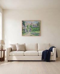Peasants’ Houses, Éragny by Camille Pissarro framed in natural oak above a cream sofa in a warm living room