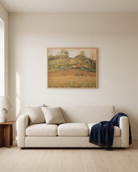 Ploughed Fields by Camille Pissarro framed in natural oak above a cream sofa in a warm living room