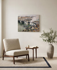 Pont Boieldieu, Rainy Day by Camille Pissarro as a stretched canvas above a linen lounge chair in a reading corner