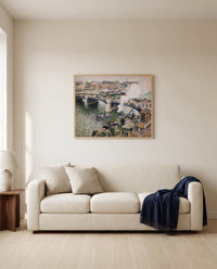 Pont Boieldieu, Rainy Day by Camille Pissarro framed in natural oak above a cream sofa in a warm living room