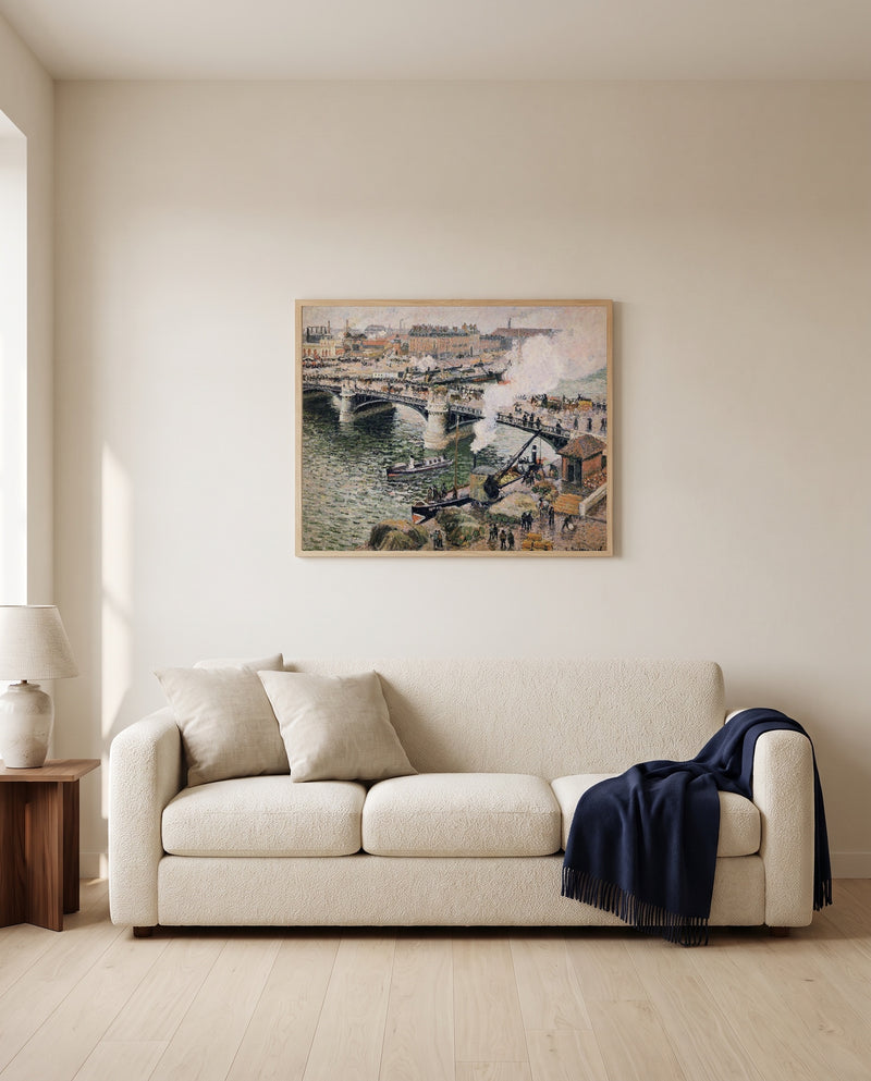 Pont Boieldieu, Rainy Day by Camille Pissarro framed in natural oak above a cream sofa in a warm living room