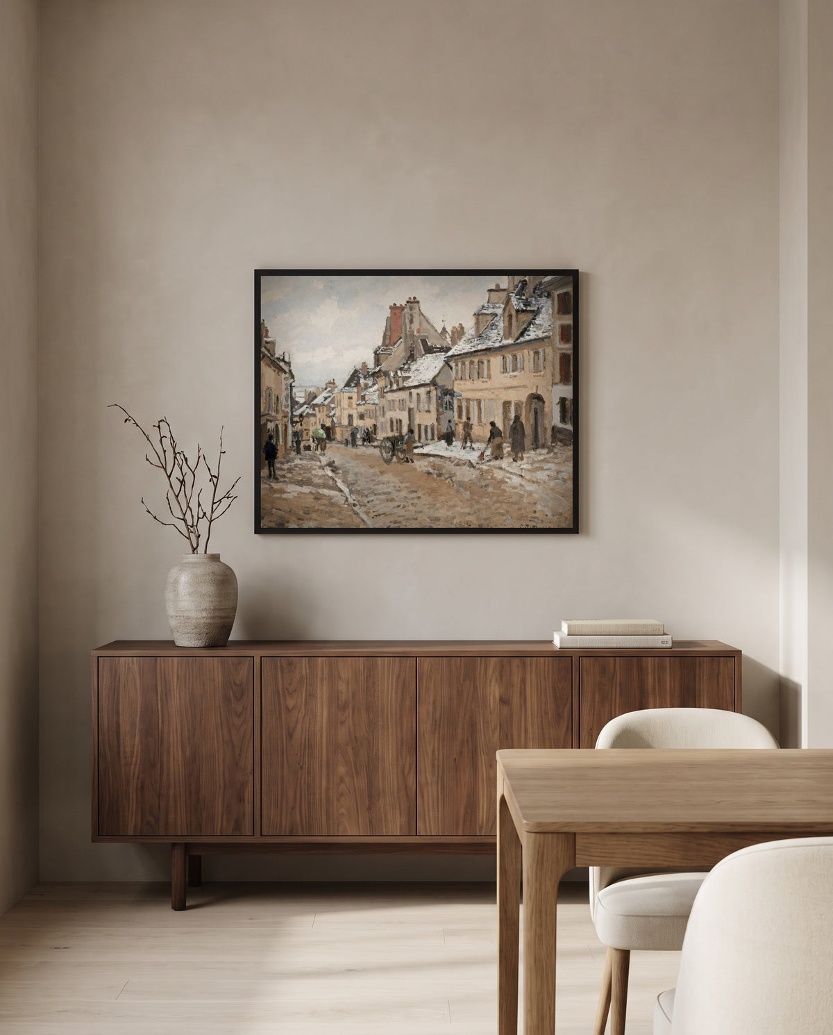 Road to Gisors, Winter by Camille Pissarro in a black frame above a walnut sideboard in a dining room