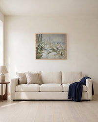 Rabbit Warren, Snow by Camille Pissarro framed in natural oak above a cream sofa in a warm living room