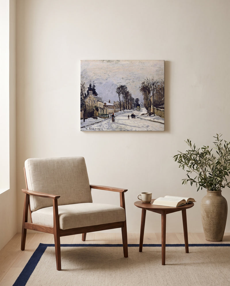 Route to Versailles by Camille Pissarro as a stretched canvas above a linen lounge chair in a reading corner
