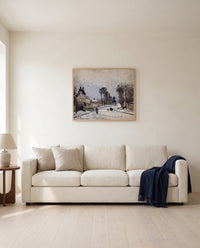 Route to Versailles by Camille Pissarro framed in natural oak above a cream sofa in a warm living room