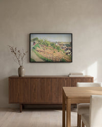 Ruelle des Poulies by Camille Pissarro in a black frame above a walnut sideboard in a dining room