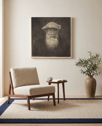Self-Portrait by Camille Pissarro as a stretched canvas above a linen lounge chair in a reading corner