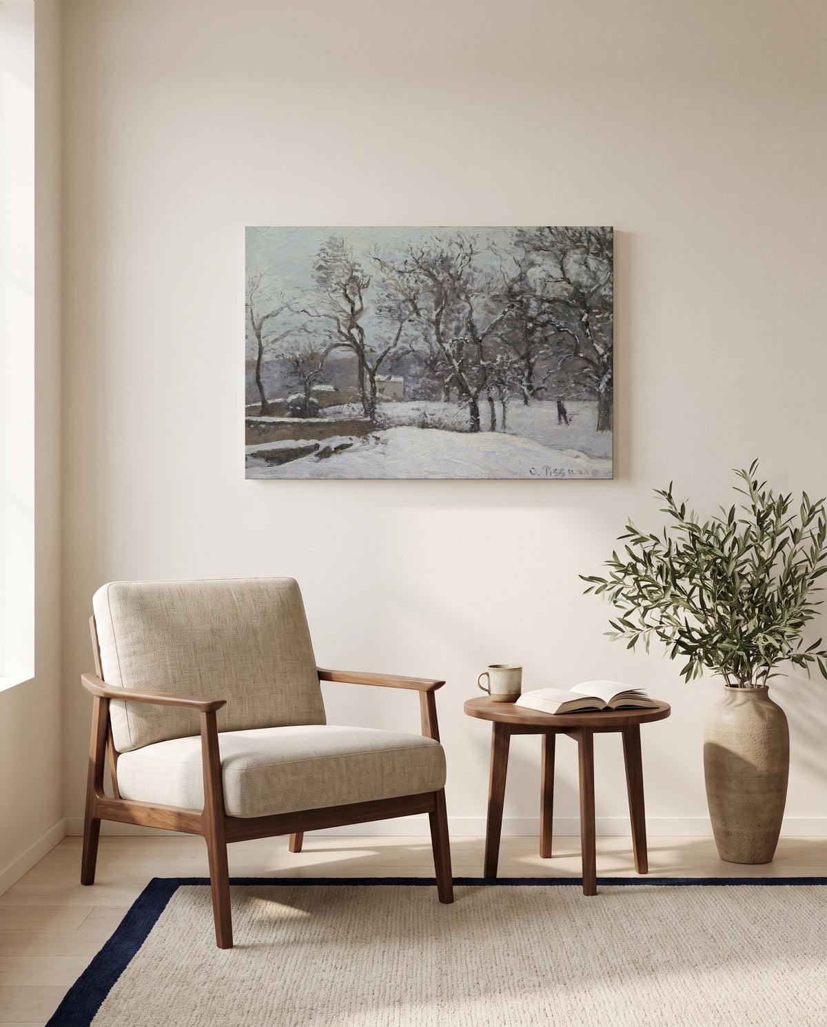 Snow at Louveciennes by Camille Pissarro as a stretched canvas above a linen lounge chair in a reading corner