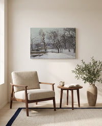 Snow at Louveciennes by Camille Pissarro as a stretched canvas above a linen lounge chair in a reading corner