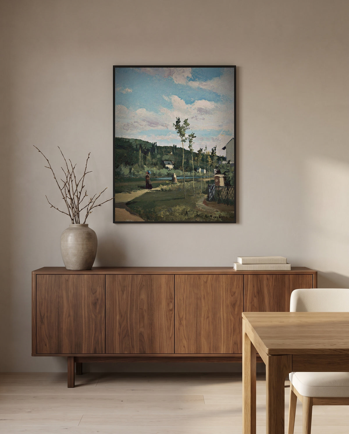 Strollers on a Country Road by Camille Pissarro in a black frame above a walnut sideboard in a dining room