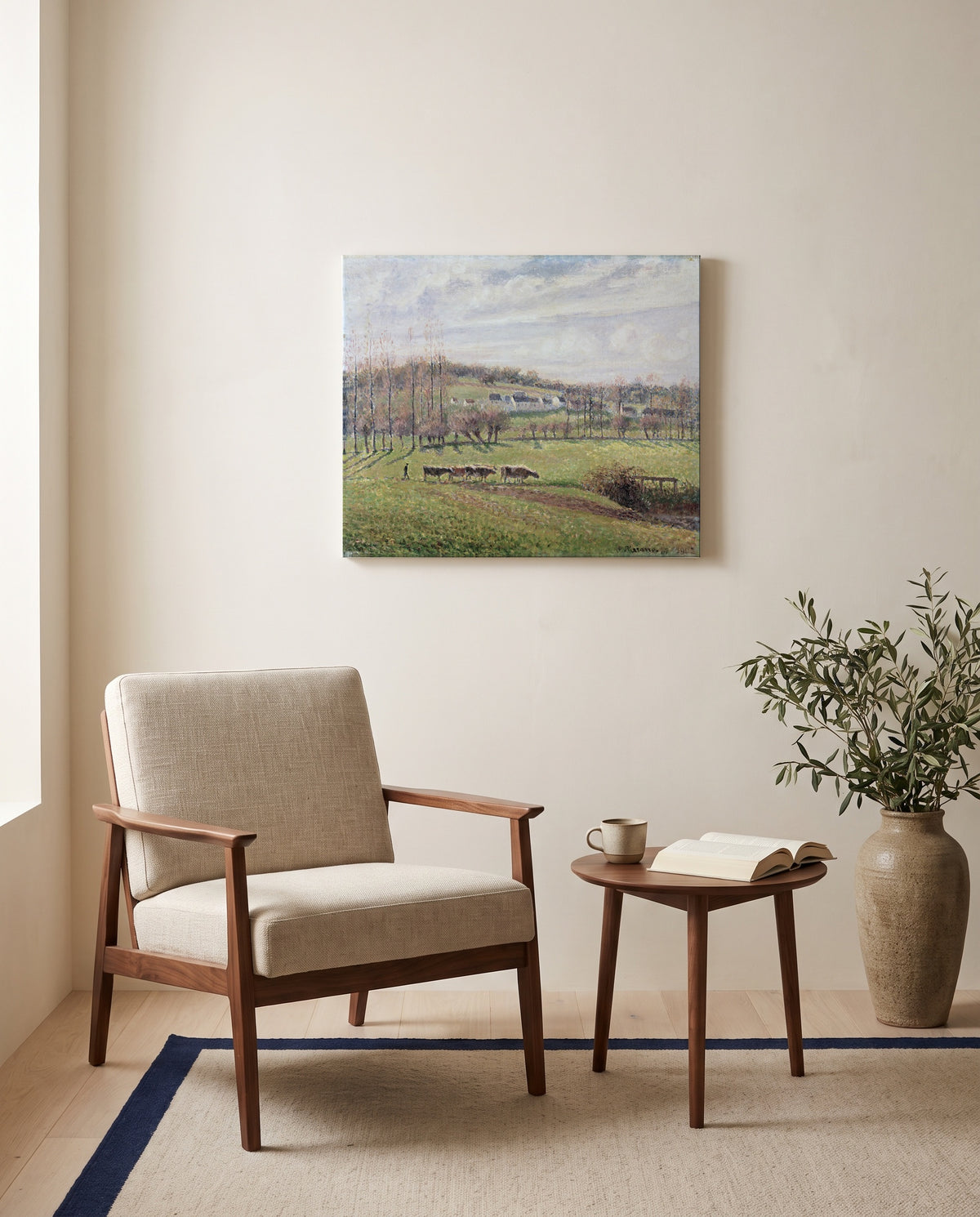 Summer Landscape, Éragny by Camille Pissarro as a stretched canvas above a linen lounge chair in a reading corner