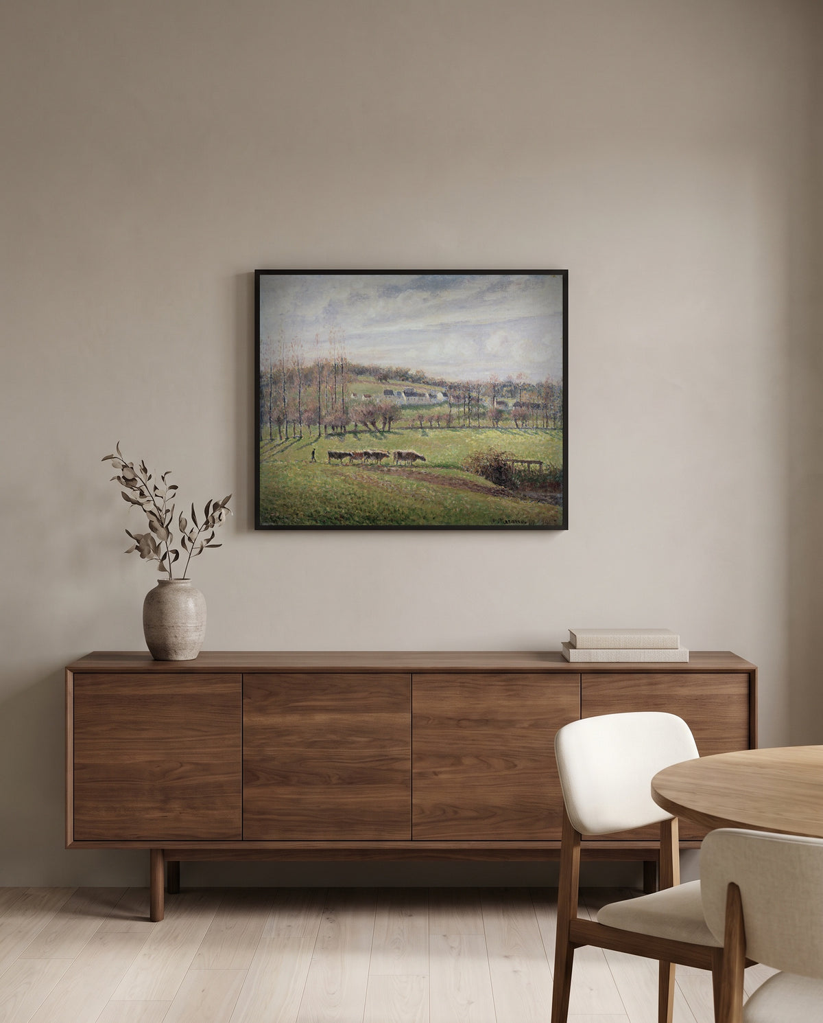 Summer Landscape, Éragny by Camille Pissarro in a black frame above a walnut sideboard in a dining room