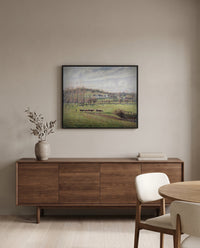 Summer Landscape, Éragny by Camille Pissarro in a black frame above a walnut sideboard in a dining room