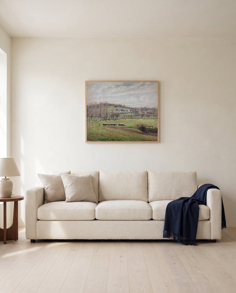 Summer Landscape, Éragny by Camille Pissarro framed in natural oak above a cream sofa in a warm living room
