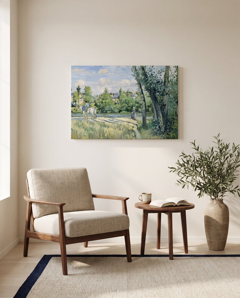 Sunlight on the Road by Camille Pissarro as a stretched canvas above a linen lounge chair in a reading corner