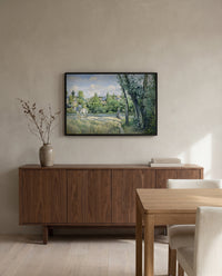 Sunlight on the Road by Camille Pissarro in a black frame above a walnut sideboard in a dining room