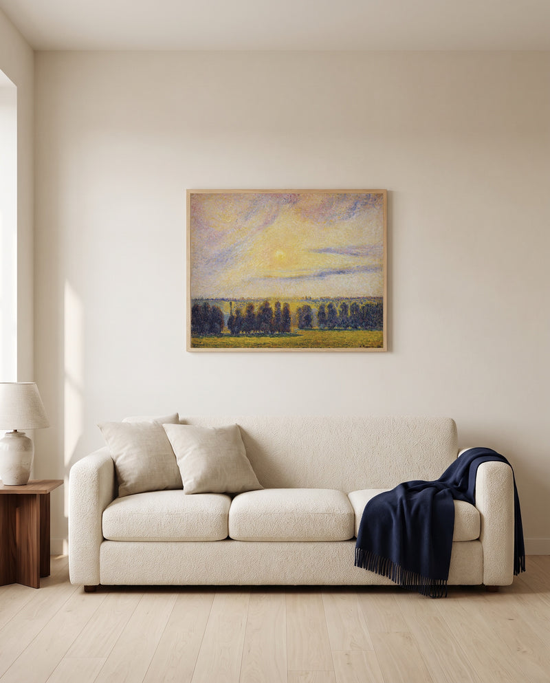 Sunset at Éragny by Camille Pissarro framed in natural oak above a cream sofa in a warm living room