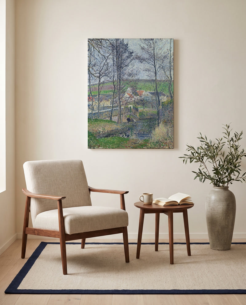 Banks of the Viosne by Camille Pissarro as a stretched canvas above a linen lounge chair in a reading corner