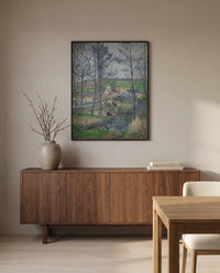 Banks of the Viosne by Camille Pissarro in a black frame above a walnut sideboard in a dining room
