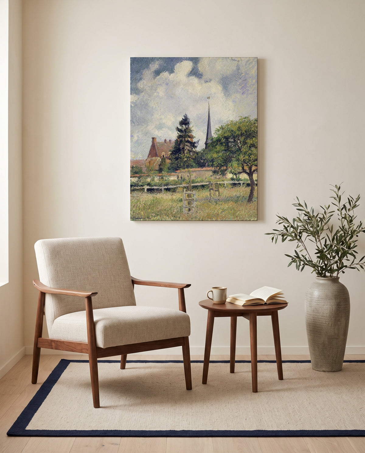 The Church at Éragny by Camille Pissarro as a stretched canvas above a linen lounge chair in a reading corner