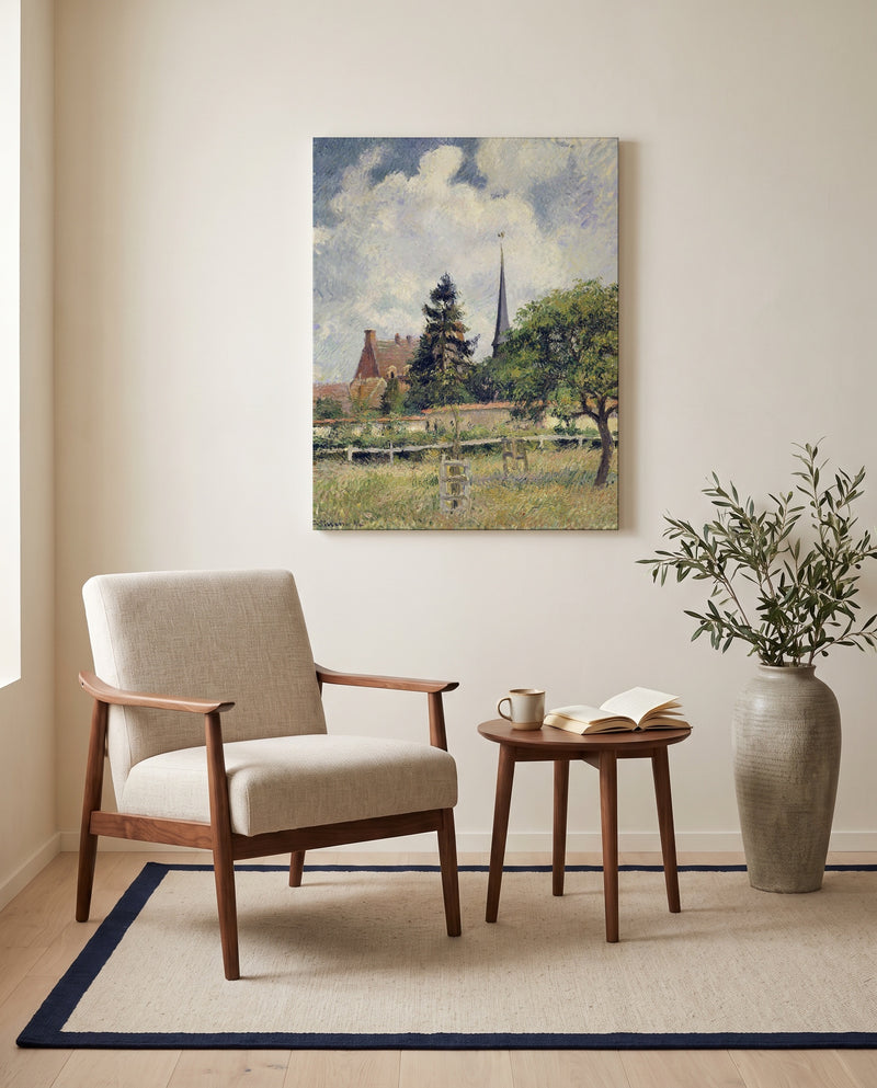 The Church at Éragny by Camille Pissarro as a stretched canvas above a linen lounge chair in a reading corner