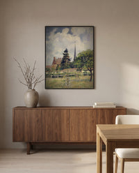 The Church at Éragny by Camille Pissarro in a black frame above a walnut sideboard in a dining room
