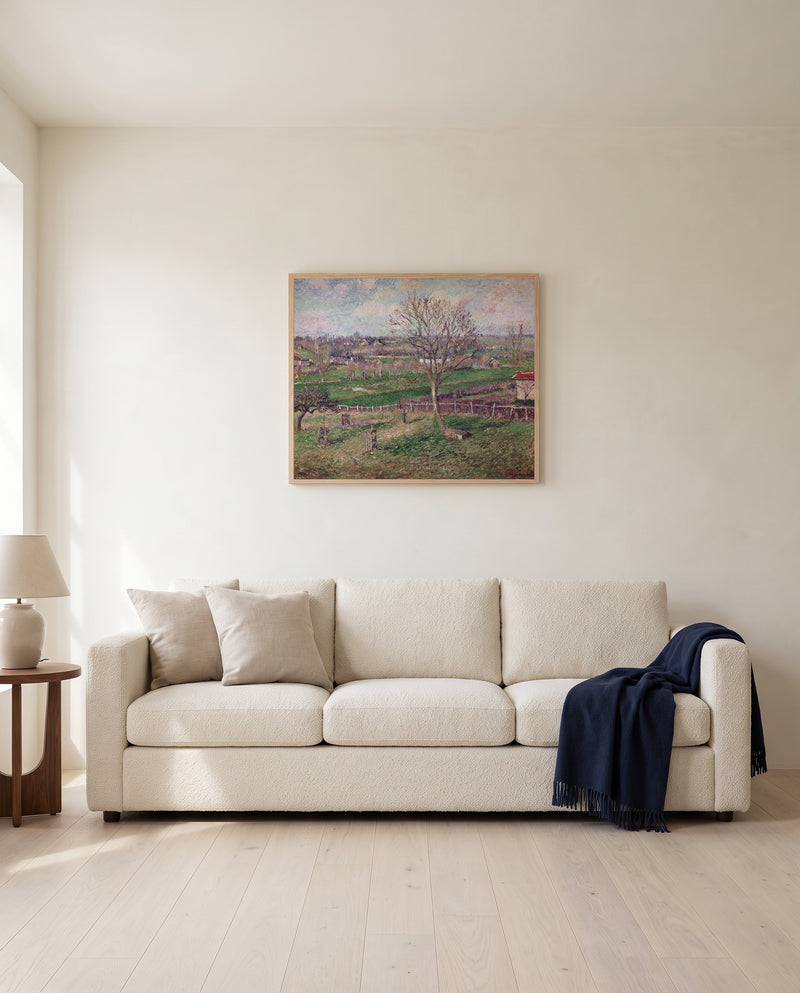 Walnut Tree in Winter by Camille Pissarro framed in natural oak above a cream sofa in a warm living room