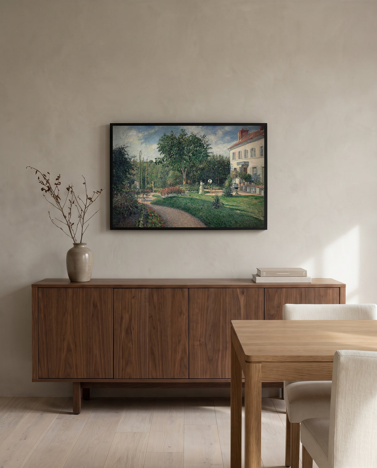Garden of Les Mathurins by Camille Pissarro in a black frame above a walnut sideboard in a dining room