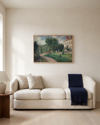 Garden of Les Mathurins by Camille Pissarro framed in natural oak above a cream sofa in a warm living room