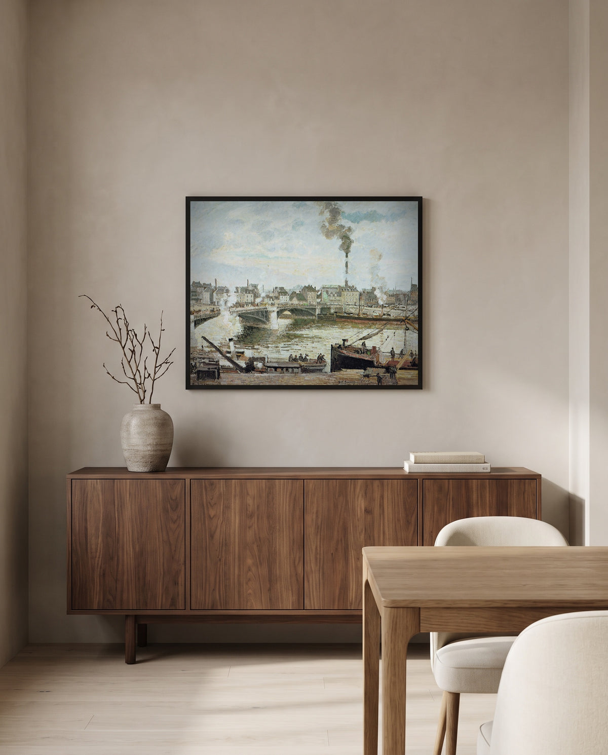 The Great Bridge, Rouen by Camille Pissarro in a black frame above a walnut sideboard in a dining room