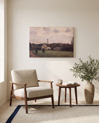 The Little Factory by Camille Pissarro as a stretched canvas above a linen lounge chair in a reading corner
