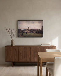 The Little Factory by Camille Pissarro in a black frame above a walnut sideboard in a dining room