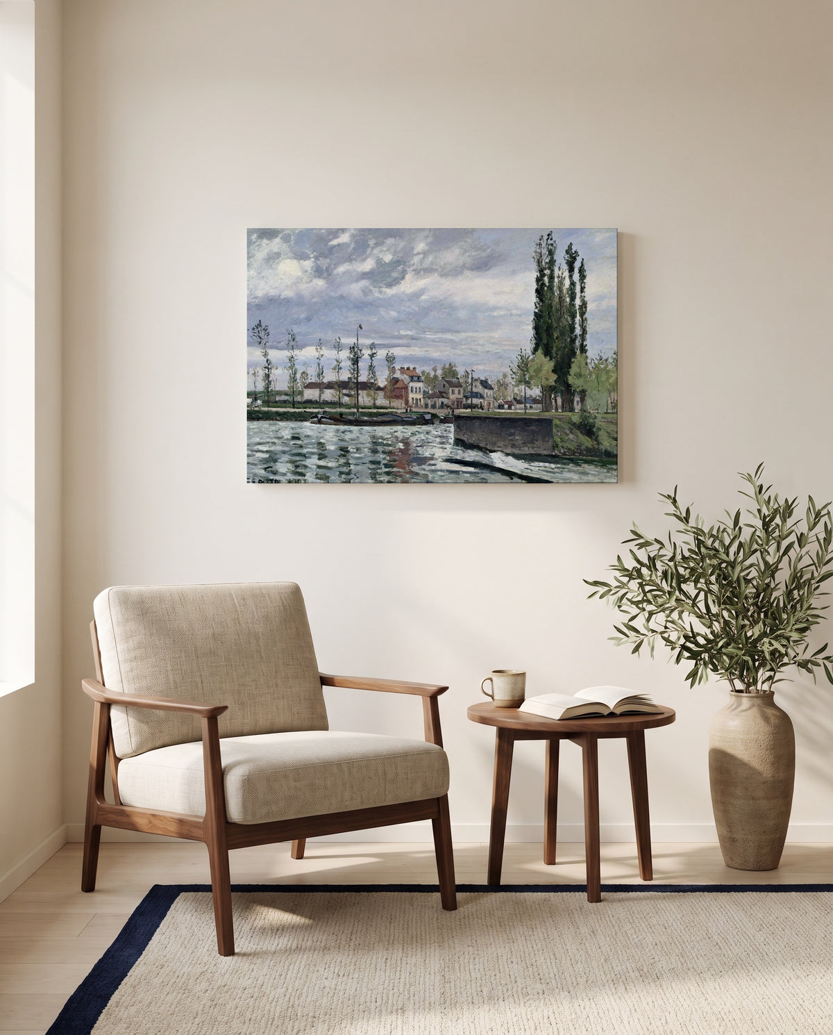 The Lock at Pontoise by Camille Pissarro as a stretched canvas above a linen lounge chair in a reading corner