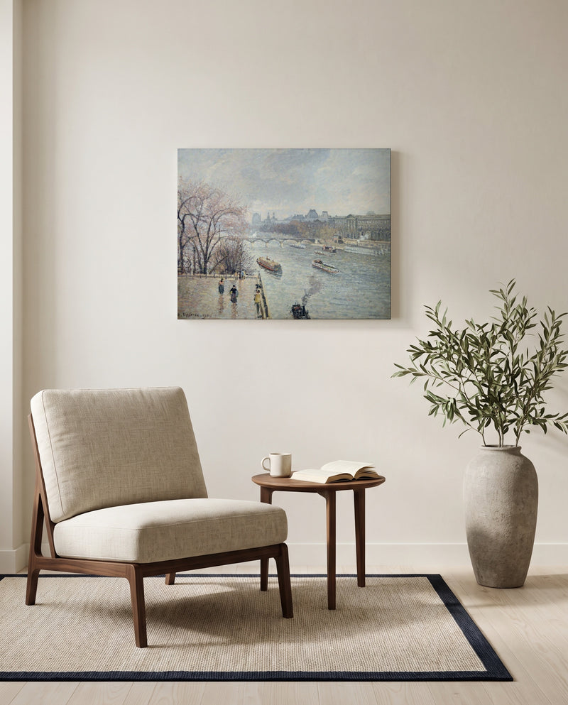 The Louvre, Rainy Weather by Camille Pissarro as a stretched canvas above a linen lounge chair in a reading corner