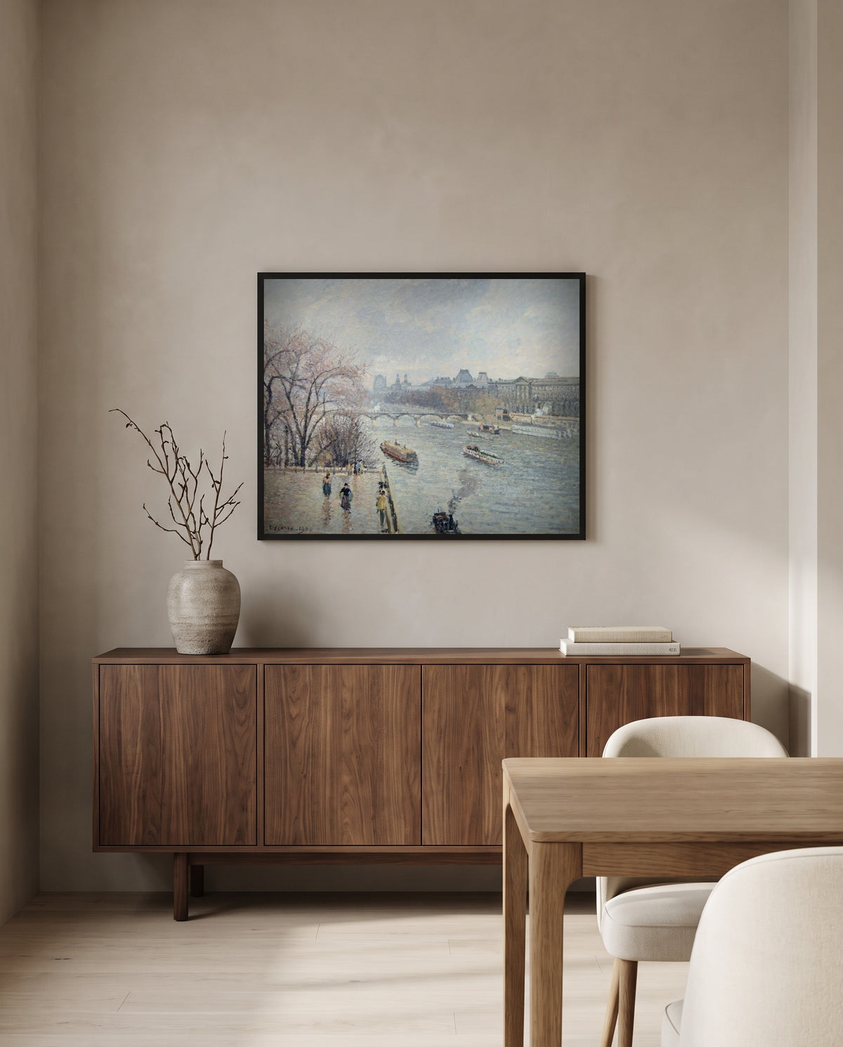 The Louvre, Rainy Weather by Camille Pissarro in a black frame above a walnut sideboard in a dining room