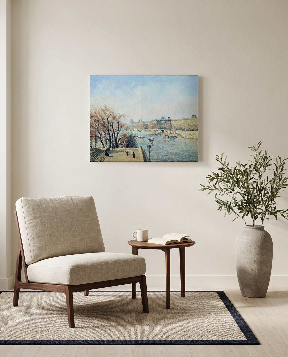 The Louvre, Morning by Camille Pissarro as a stretched canvas above a linen lounge chair in a reading corner