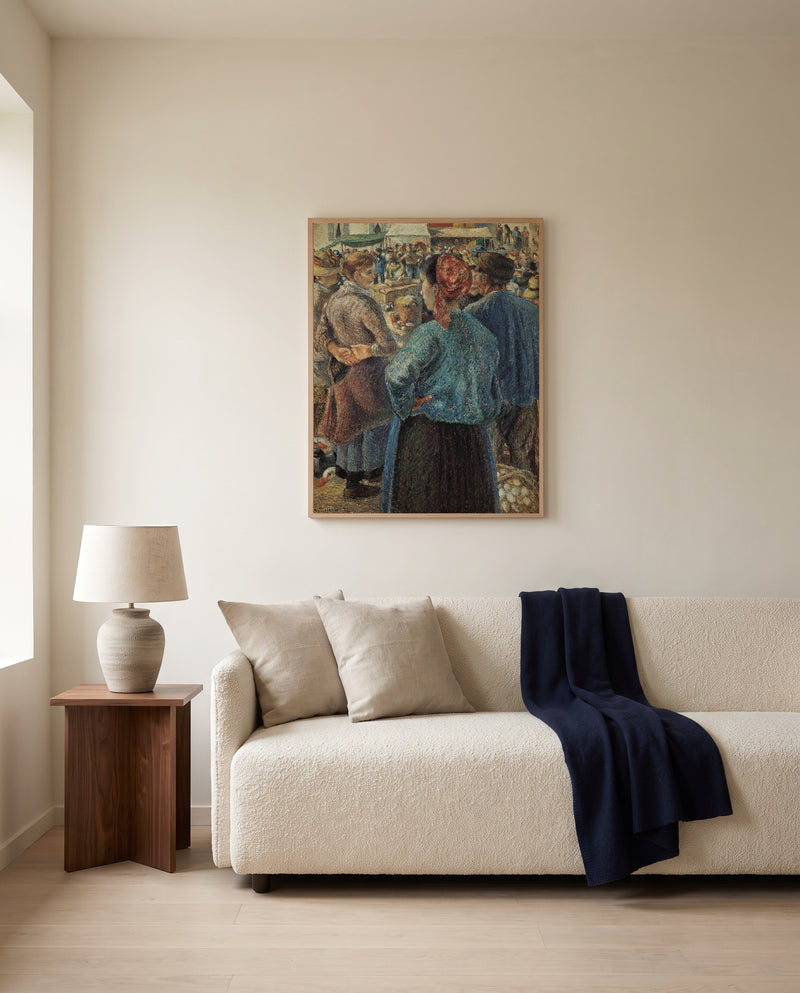 Poultry Market, Pontoise by Camille Pissarro framed in natural oak above a cream sofa in a warm living room