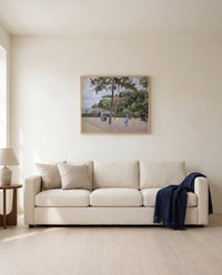 Public Garden, Pontoise by Camille Pissarro framed in natural oak above a cream sofa in a warm living room